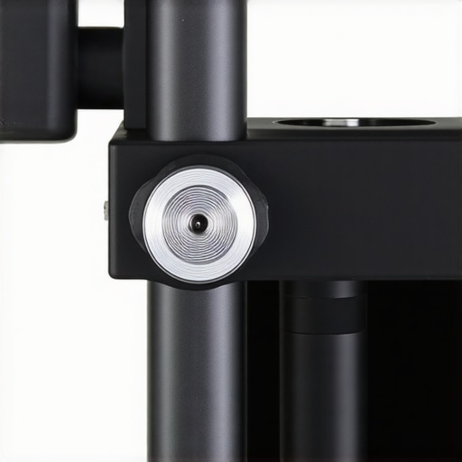 Close-up view of the tension control knob on a metal monitor arm, showcasing its build and design.